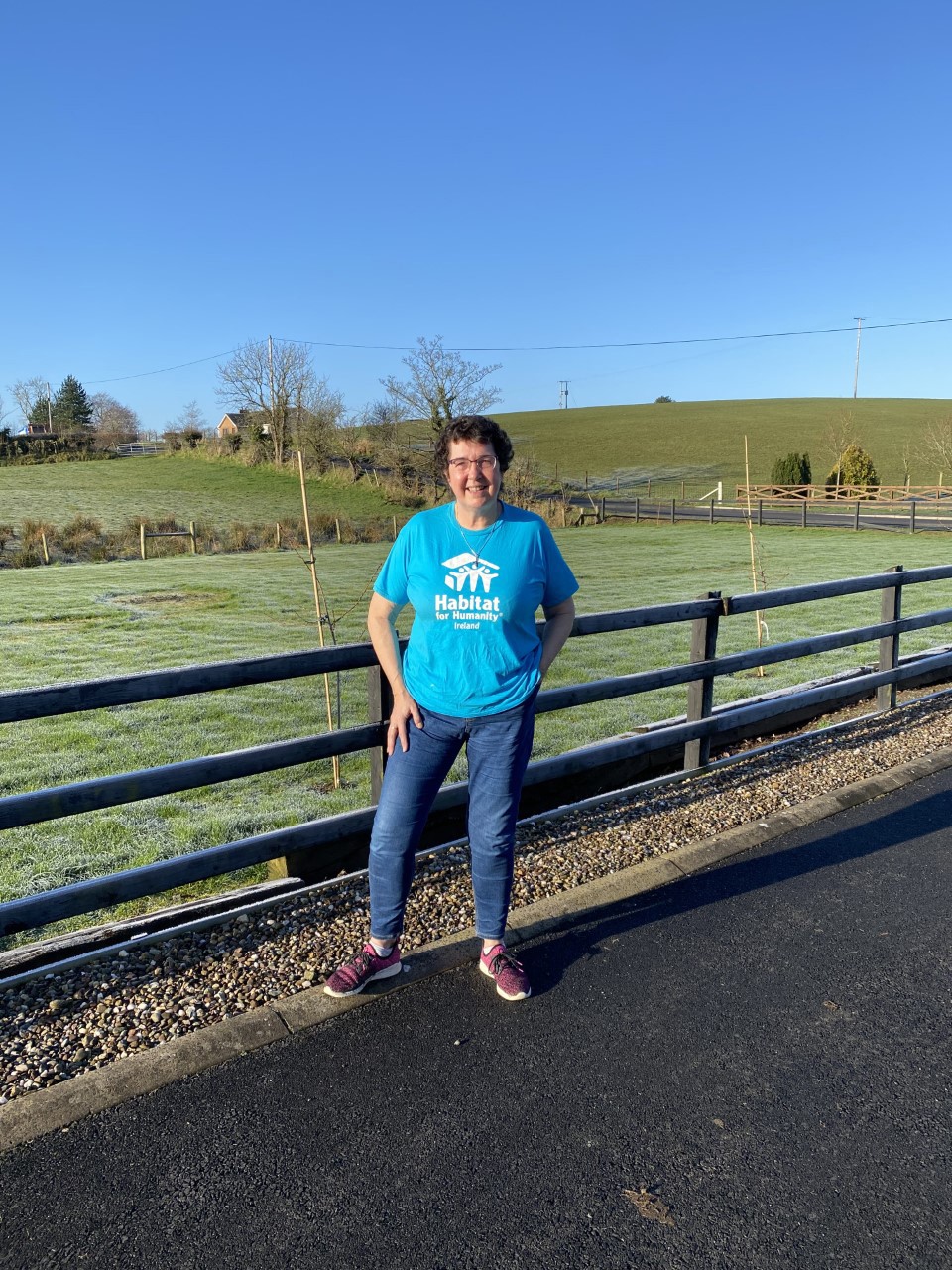 Jenny Williams wearing a blue Habitat t-shirt in front of a green field 